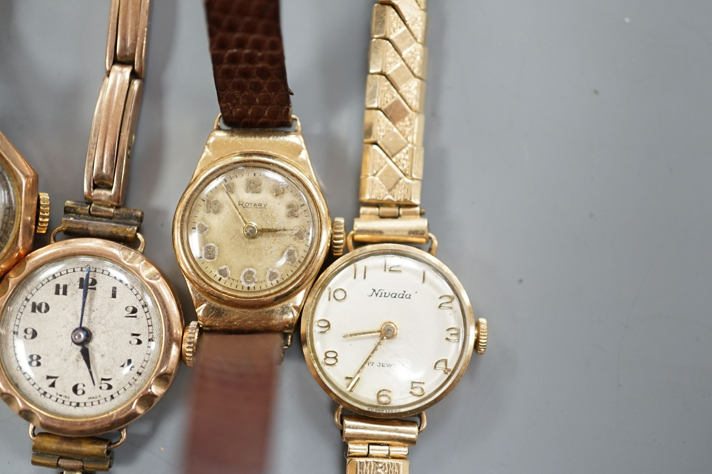 Three lady's early to mid 20th century 9ct gold manual wind wrist watches, one on a 9ct bracelet and one other yellow metal wrist watch